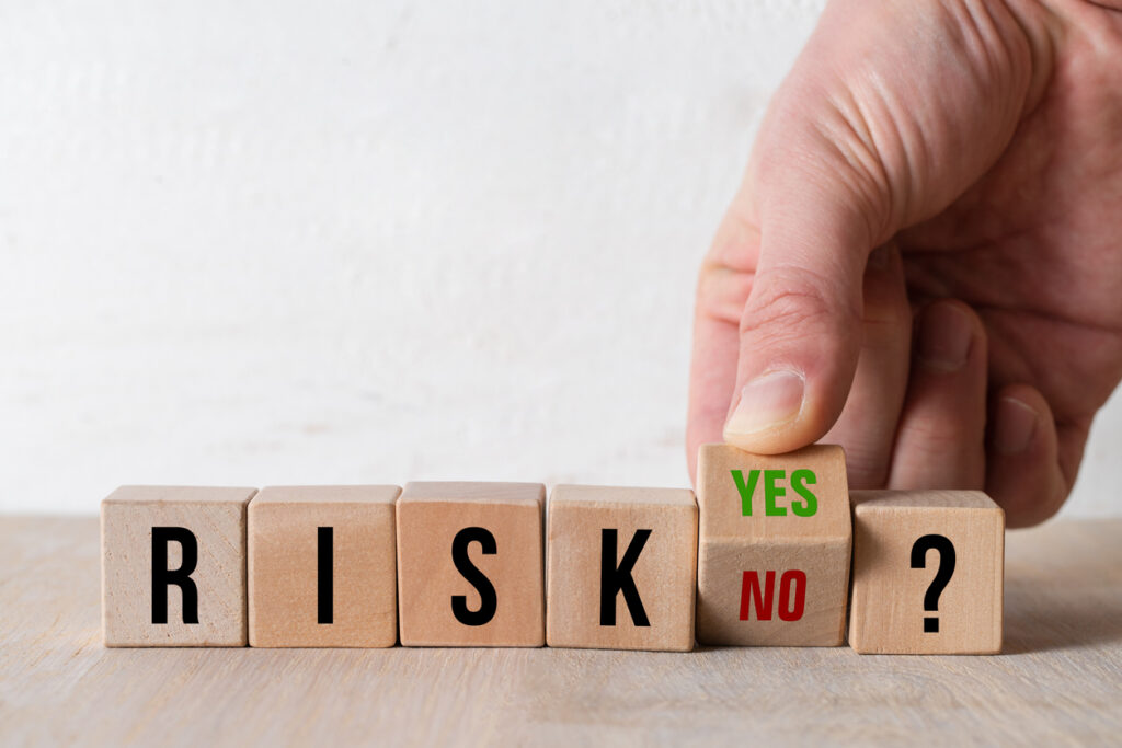 hand turning the cube with the answers YES and NO to the message RISK?